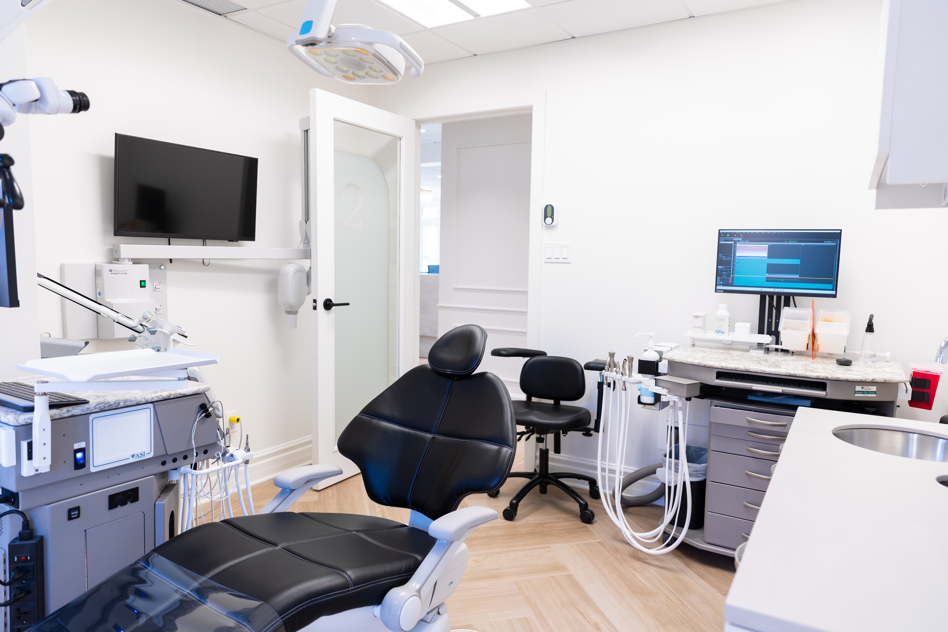 Secondary endodontic operatory with ASI treatment cart, digital workstation, and integrated clinical technology